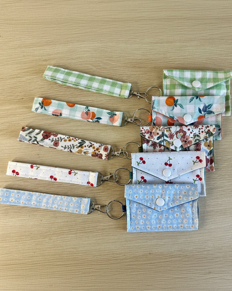 Set of fabric keychains and pouches on a wooden surface
